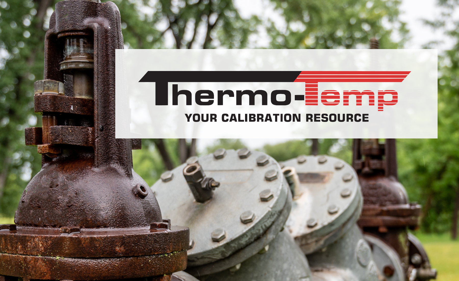 An old backflow preventer in a field with Thermo-Temp logo over top of the image.